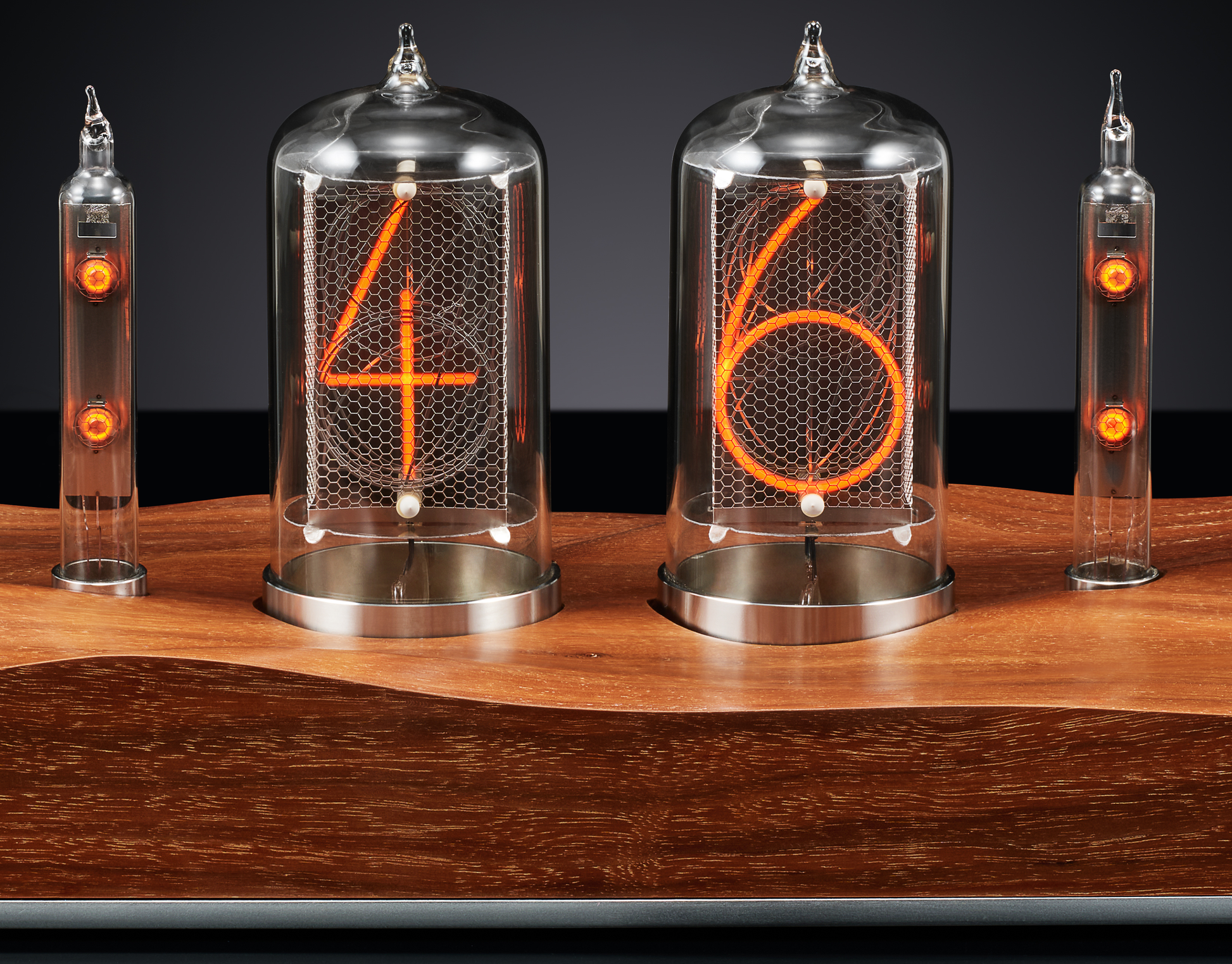 Close up of Nixie clock with a carved walnut base