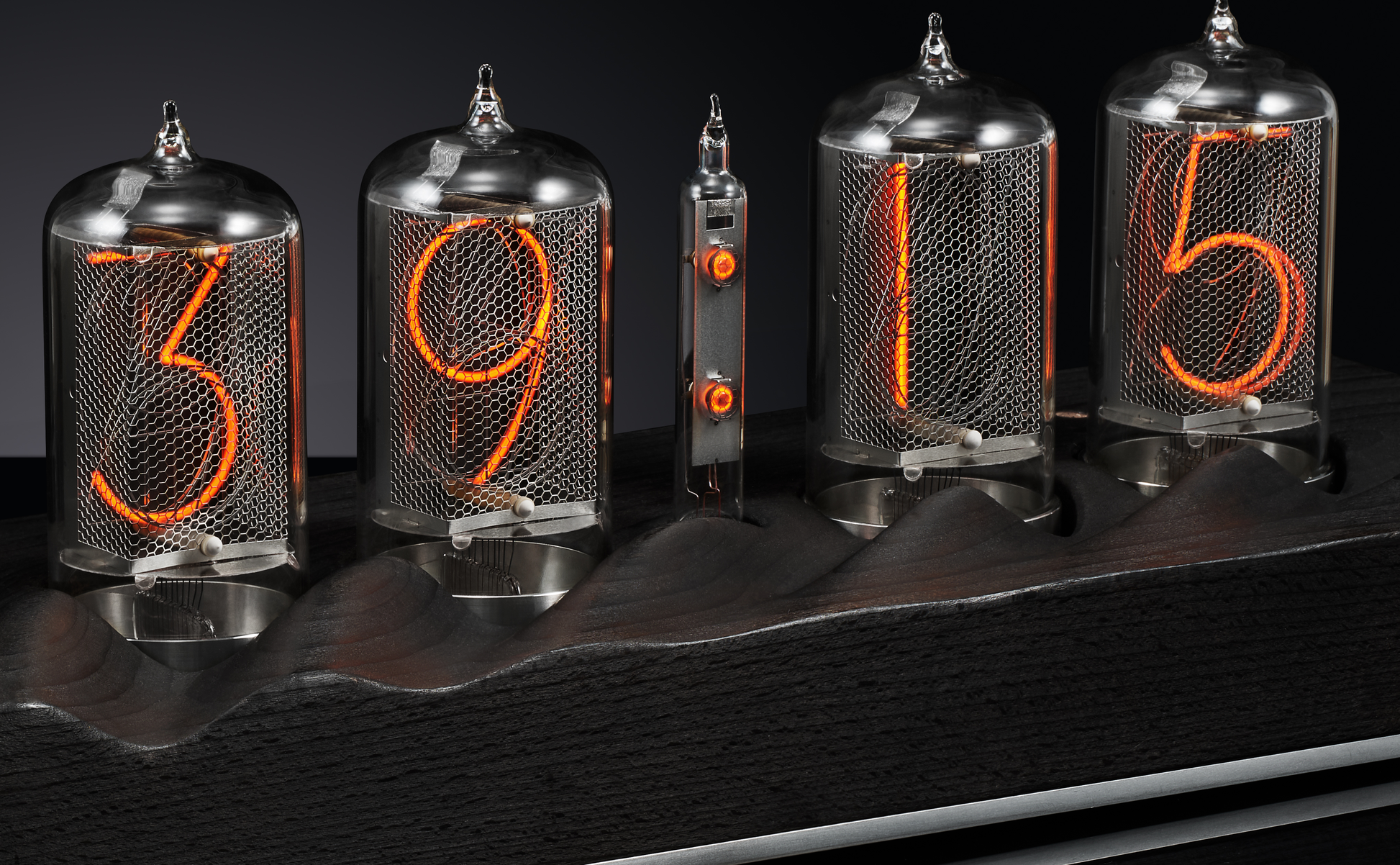 Close up of nixie clock with burnt black wood base